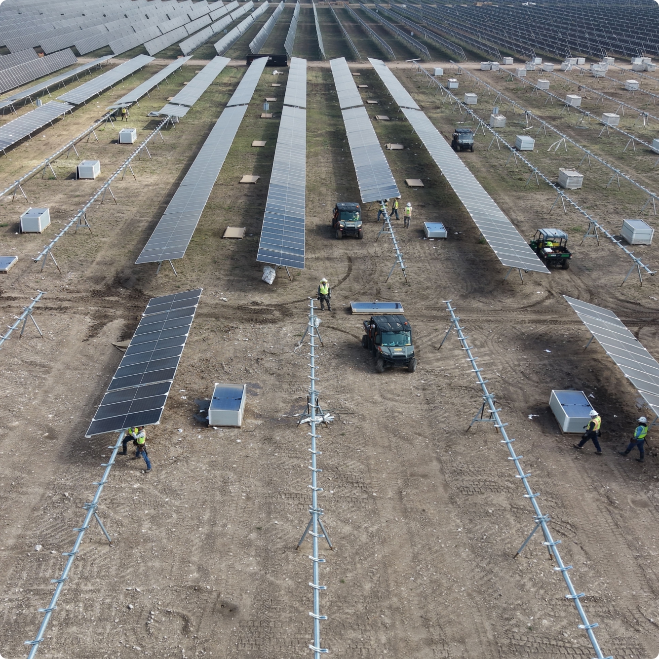 Workers installing solar panels at the AC Ranch renewable energy project site.