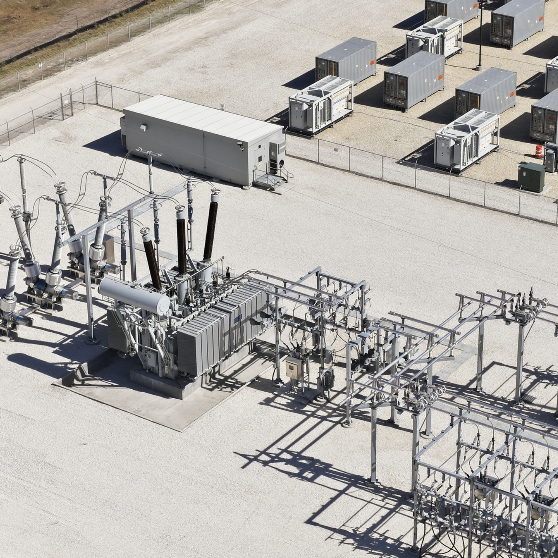 Electrical substation and grid-scale battery energy storage system at an energy facility.