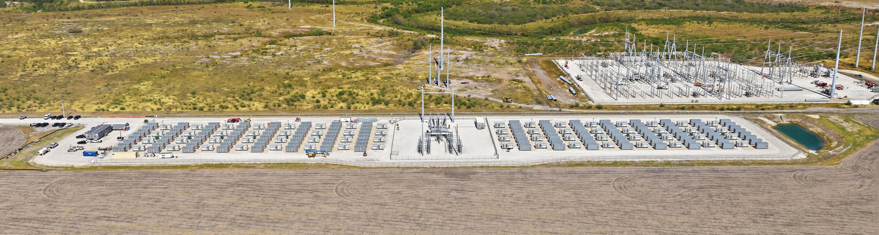 Aerial view of a grid-scale battery energy storage facility and electrical substation.