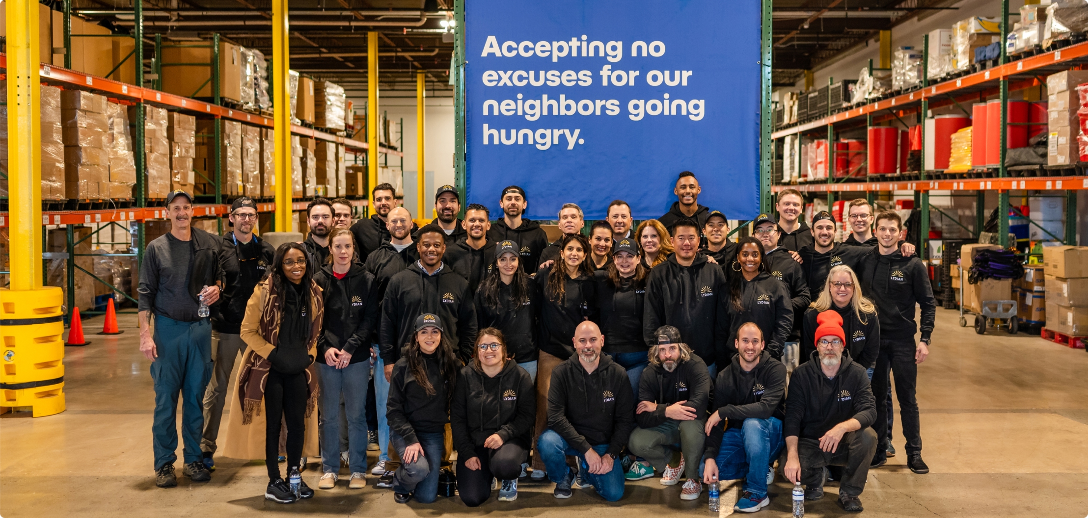 Lydian team members volunteering together at a community food bank.