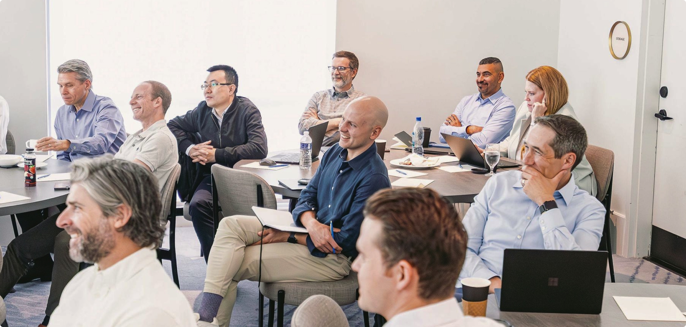 Lydian team members participating in a company meeting and discussion.