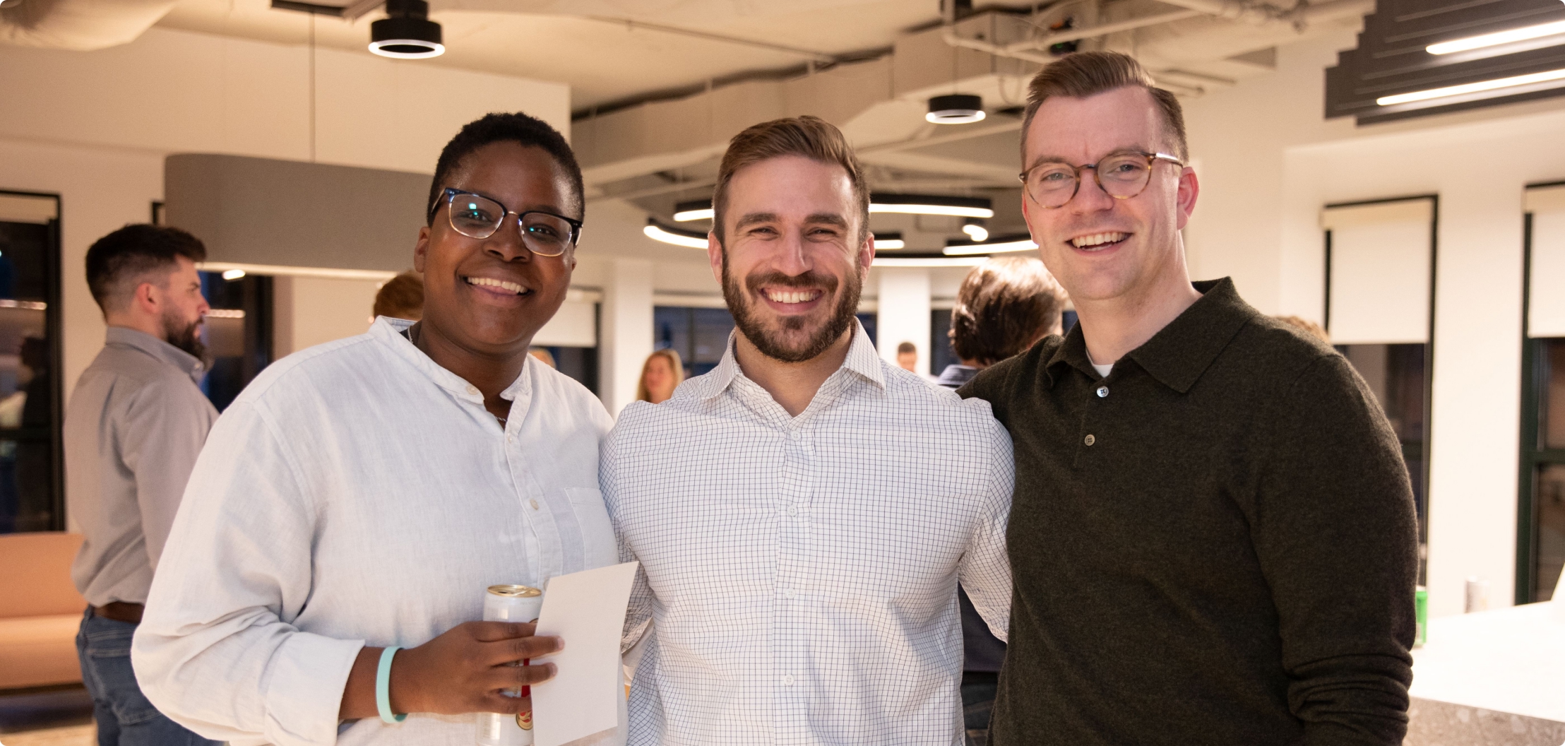 Lydian team members at a company gathering in the office.