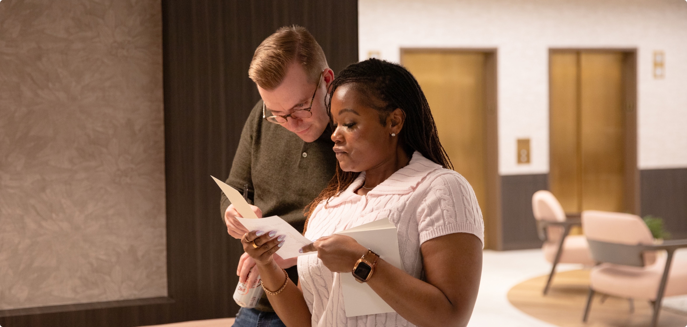 Lydian team members reviewing materials together during a company event.